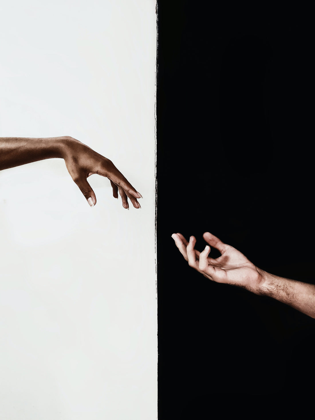 black and white hand coming together