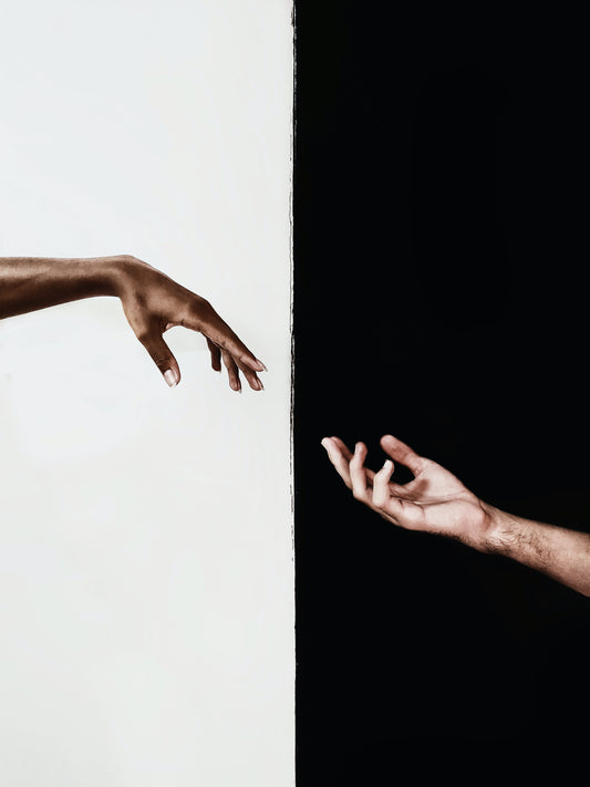 black and white hand coming together